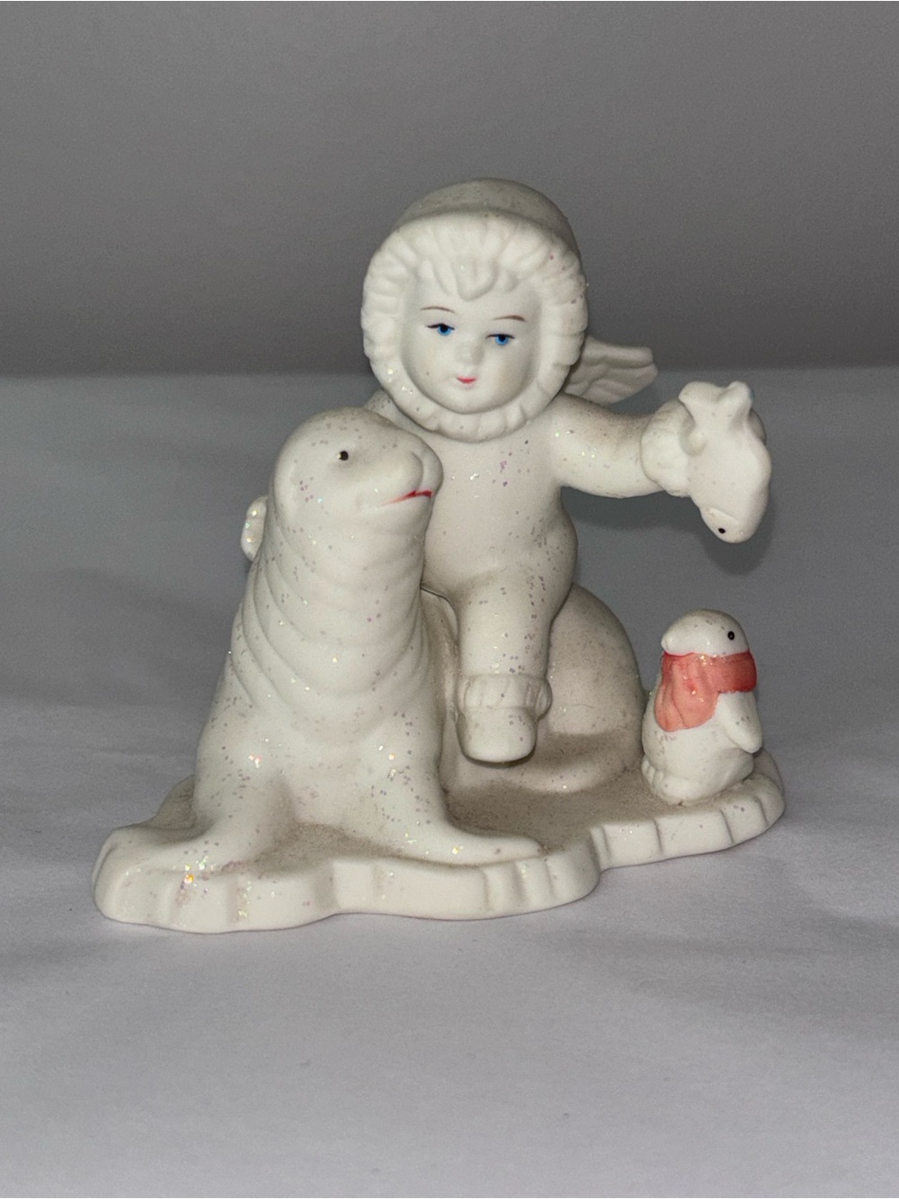 Snowbabies figurine child sitting on seal with penguin in scarf glitter Dept 56